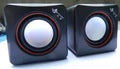 Small black square USB computer speaker model 700B on a desk.