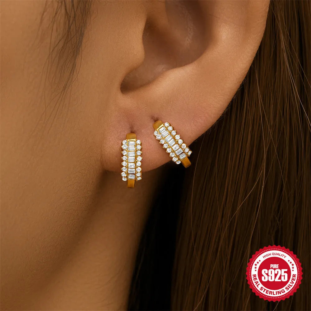 Sterling silver geometric stud earring with a central diamond detail on a white background.