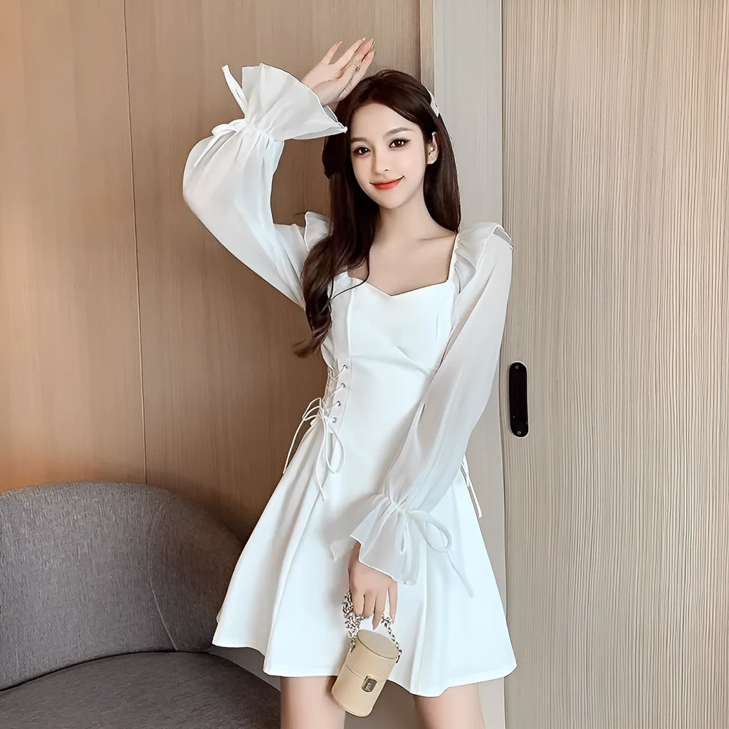 White chiffon patchwork dress with long sleeves and a waist-slimming fit on a mannequin.