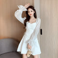White chiffon patchwork dress with long sleeves and a waist-slimming fit on a mannequin.