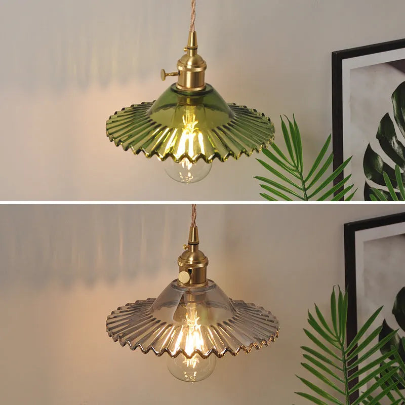 Retro brass lotus wall lamp with glass shade mounted on a beige wall, showcasing its copper arm and layered design.