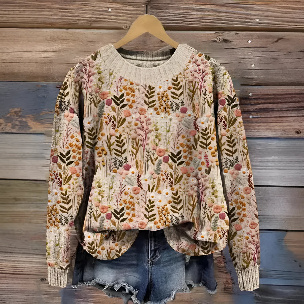Women's little flower digital printed round neck long sleeve knitted sweater on a hanger.