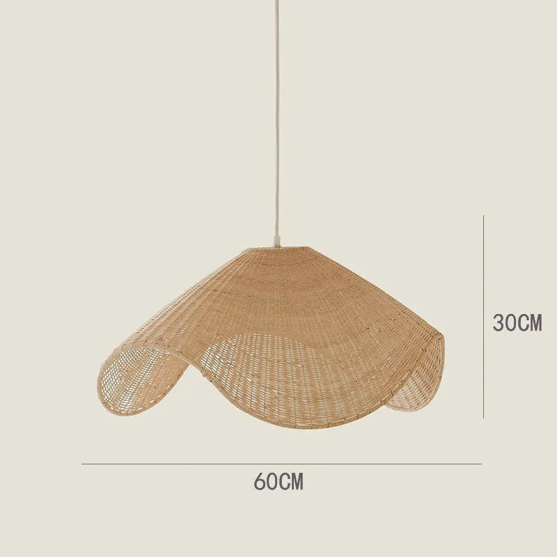 Handmade bamboo rattan chandelier with woven straw and willow lampshade in warm light