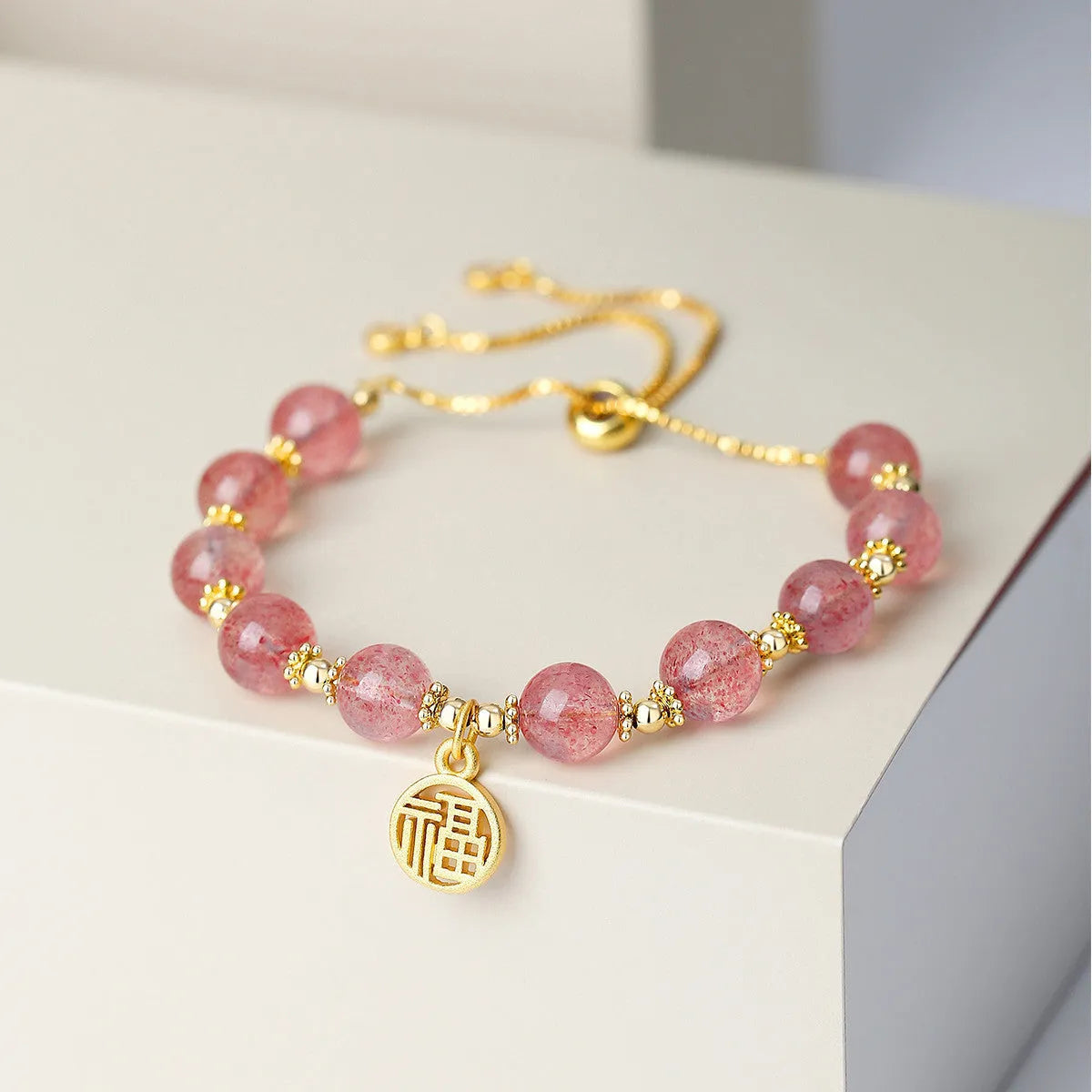Women's strawberry quartz crystal bracelet with geometric shape and silver fu character design