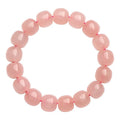 Close-up of a pink natural crystal bracelet with polished barrel-shaped beads measuring 8-10mm.