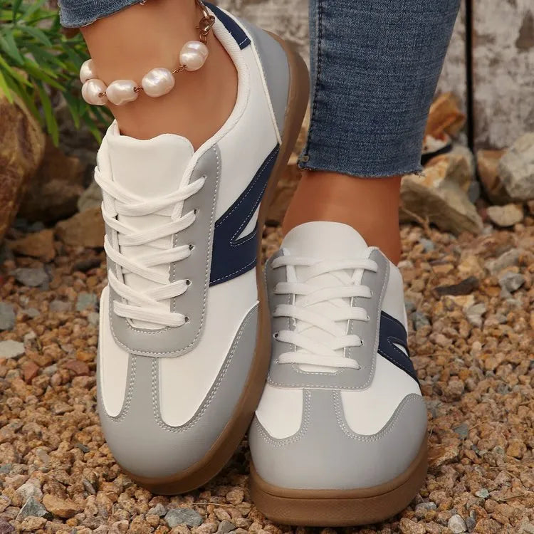 Blue women's low-top training shoes with rubber sole and front lace-up closure