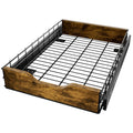 Black wooden and iron pull-out storage basket drawer for kitchen organisation on a shelf.