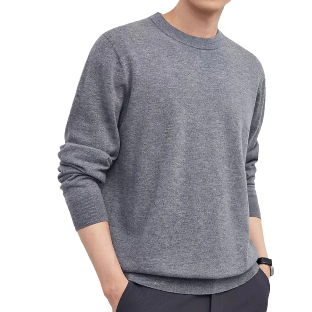Man wearing a standard wool pullover sweater in light grey, regular fit, for autumn and winter.
