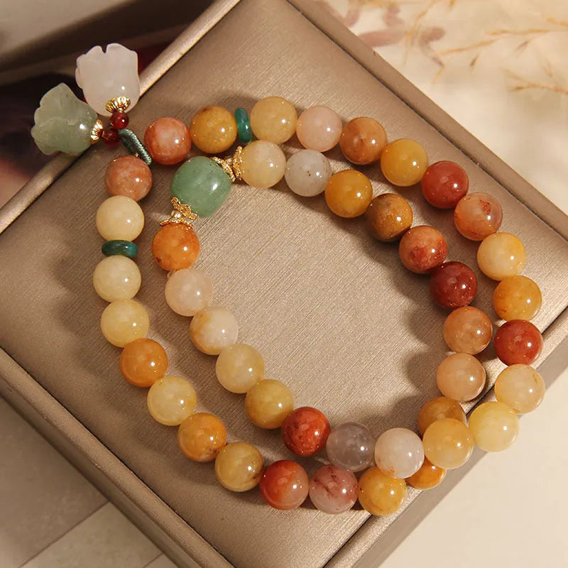 Natural jade multi-strand bracelet for women with an orchid pendant and adjustable clasp.