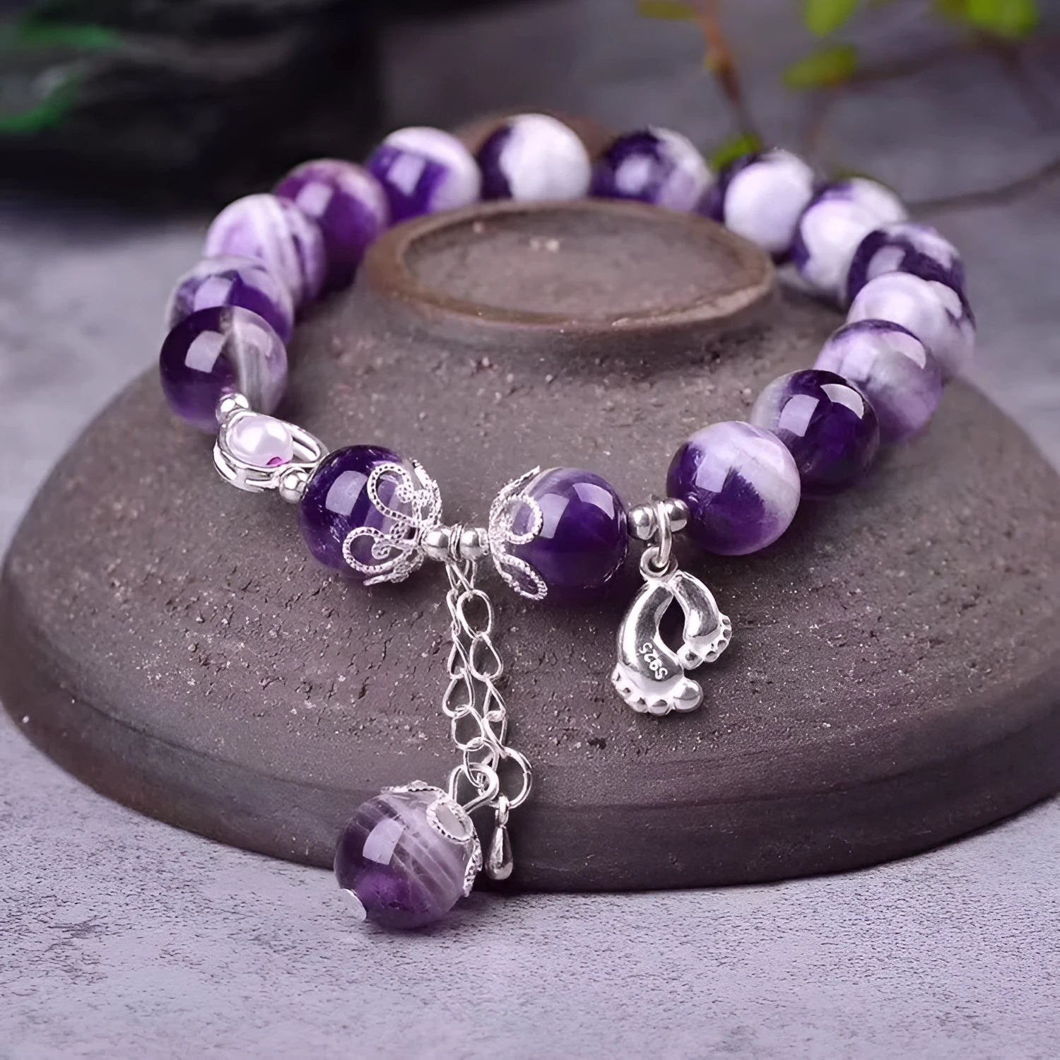 Purple amethyst gemstone bracelet with 10mm round beads on woman's wrist