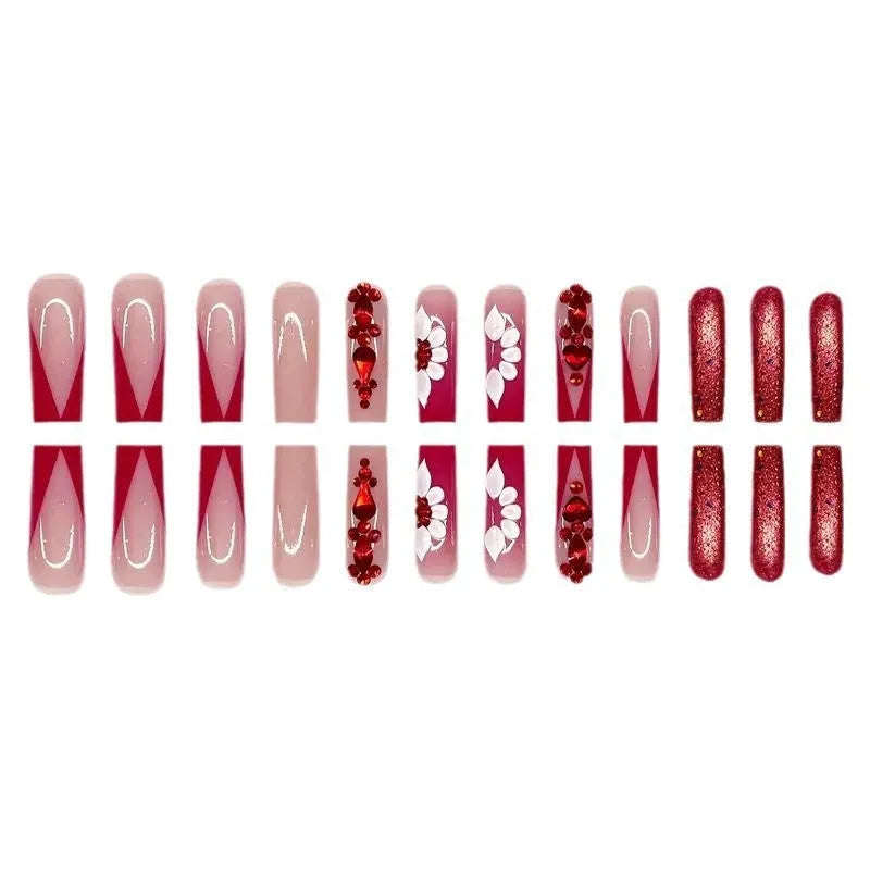 Long European square fake nails with sweet floral pattern and prismatic red diamond crystal accents.