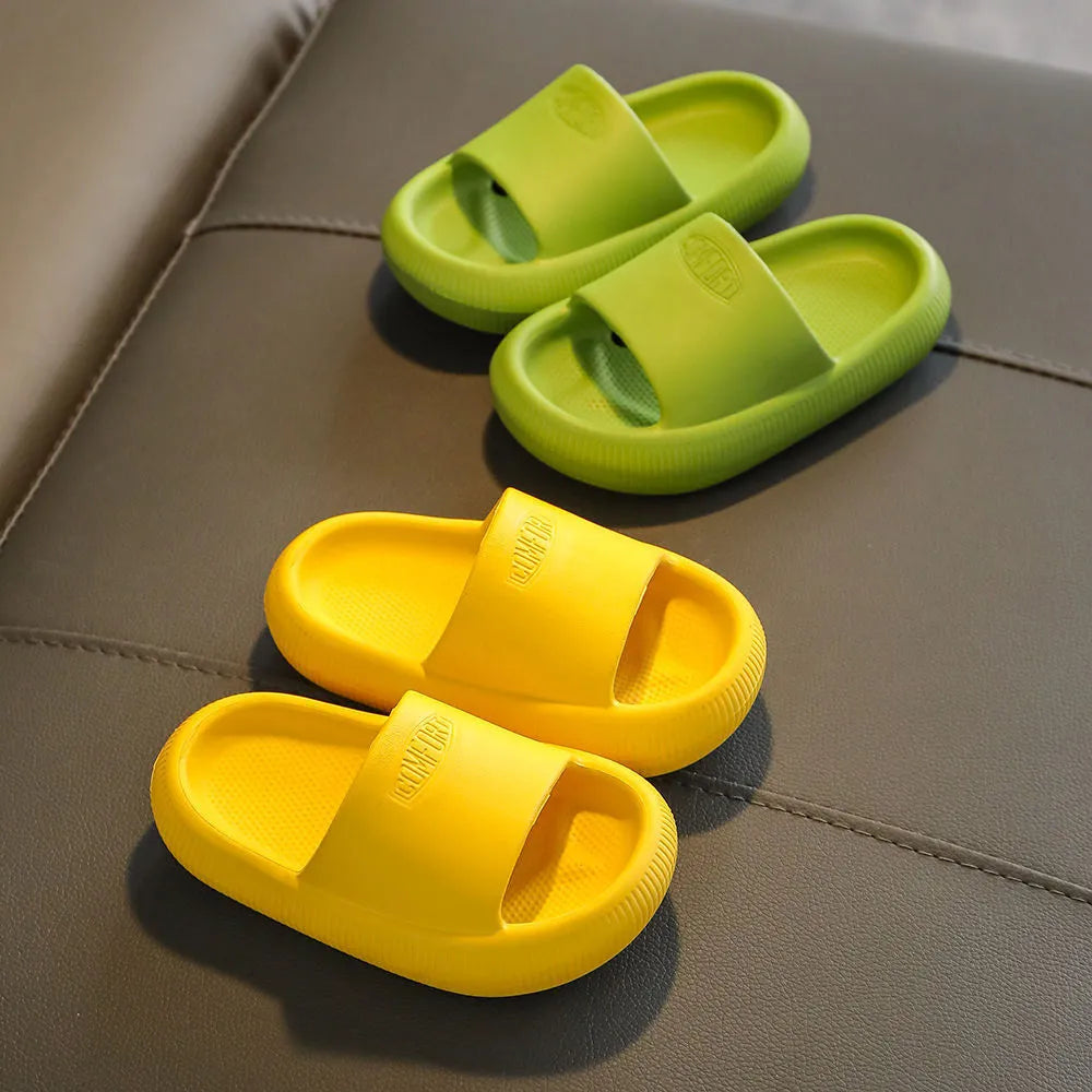 Colourful children's EVA slippers with textured sole, shown in blue, green, orange, pink, and yellow.