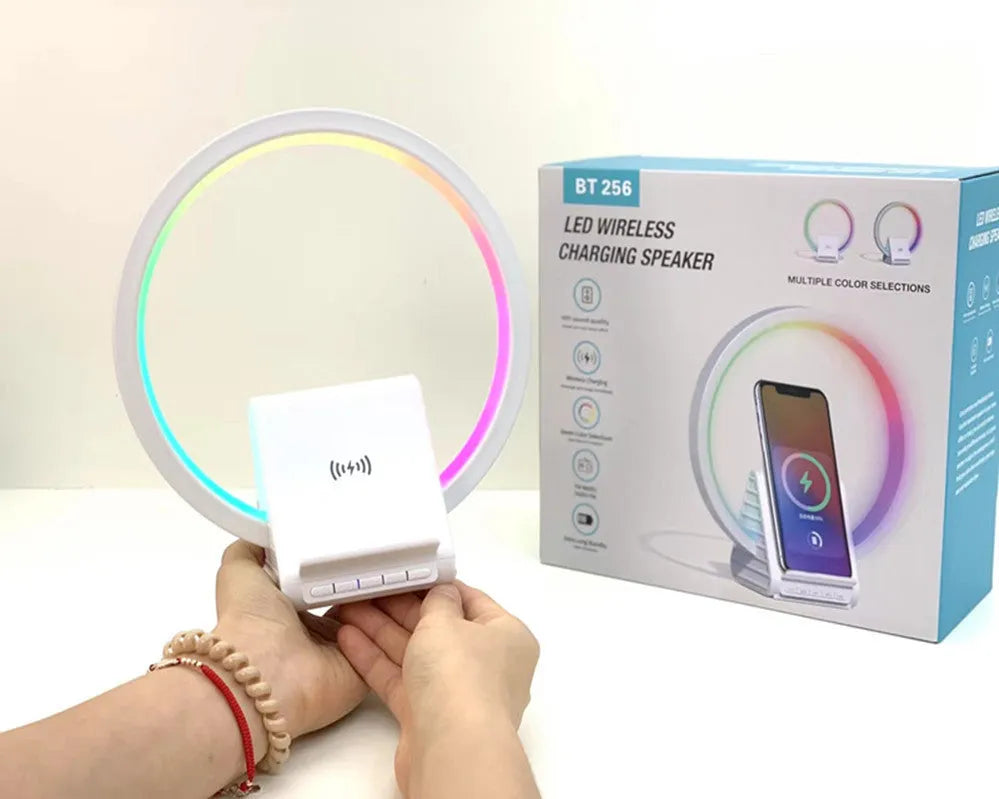 White smart Bluetooth speaker with wireless charging surface and ambient lighting