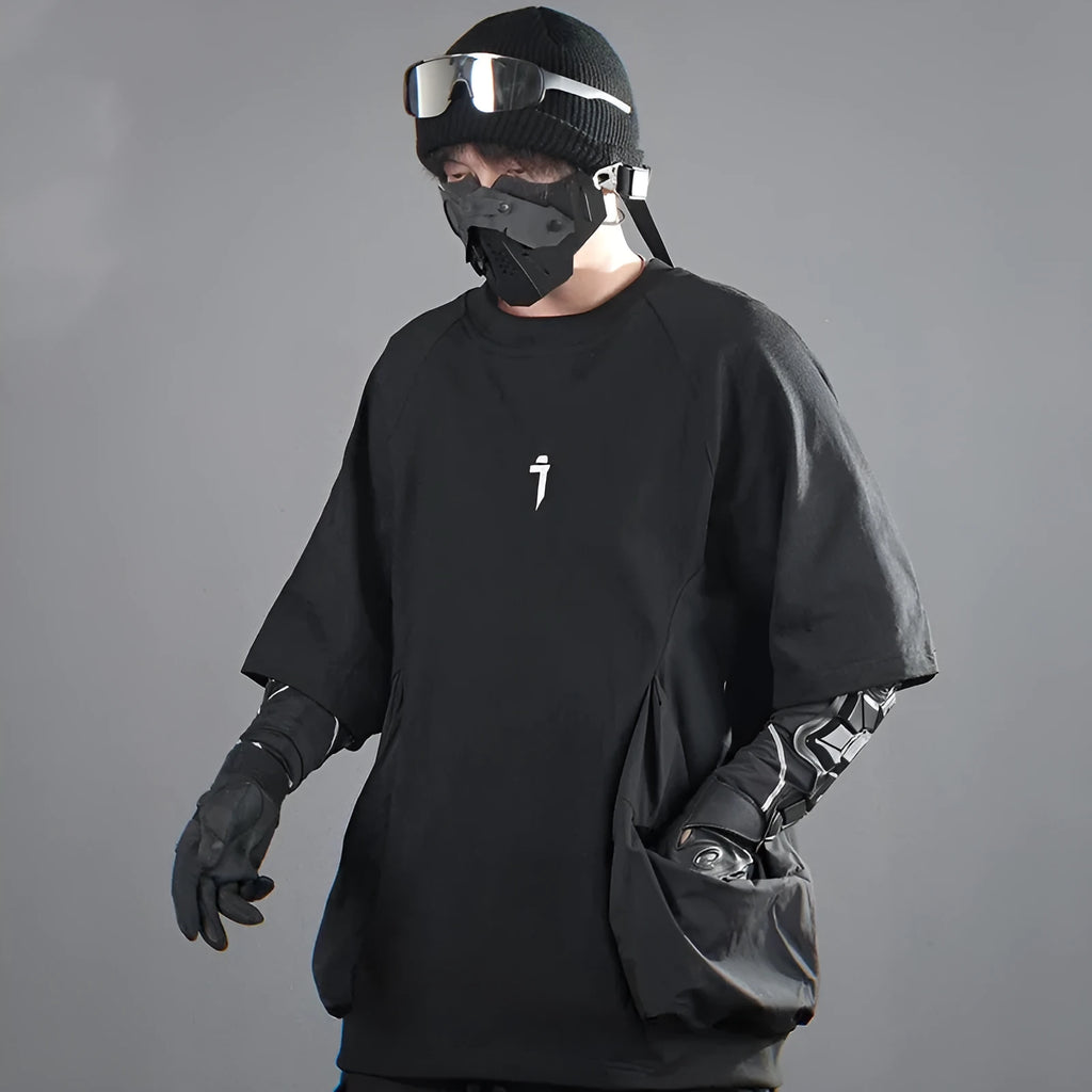 A man's loose black cotton T-shirt with large chest pockets and short sleeves.