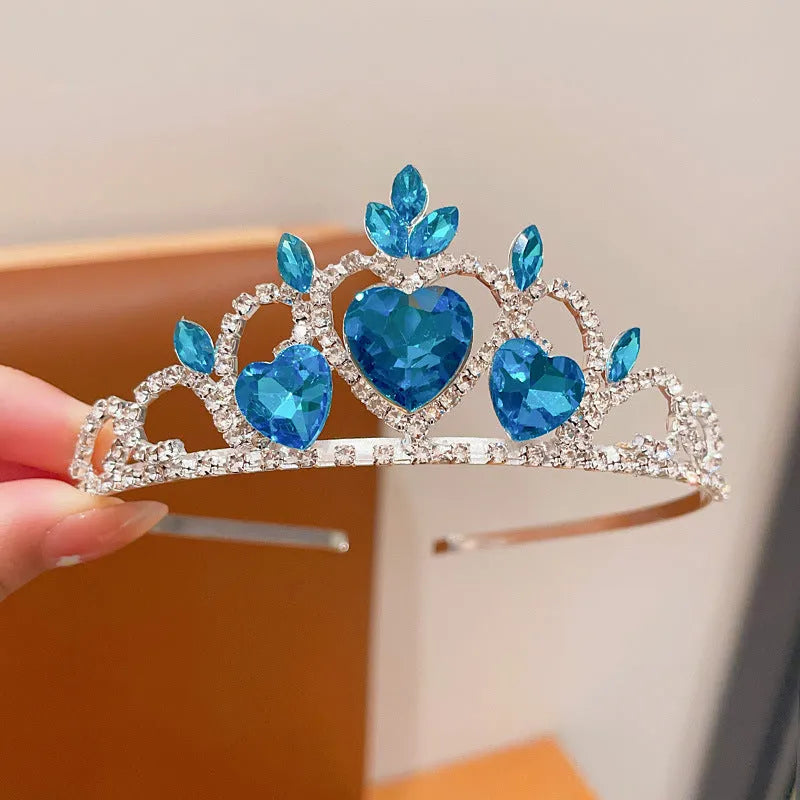 Girl's shiny metal headband with a crystal crown design in pink, light blue, and light purple colours.