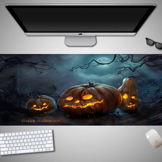 Large Halloween patterned gaming mouse pad on a desk showing non-slip rubber base and extra-long design.