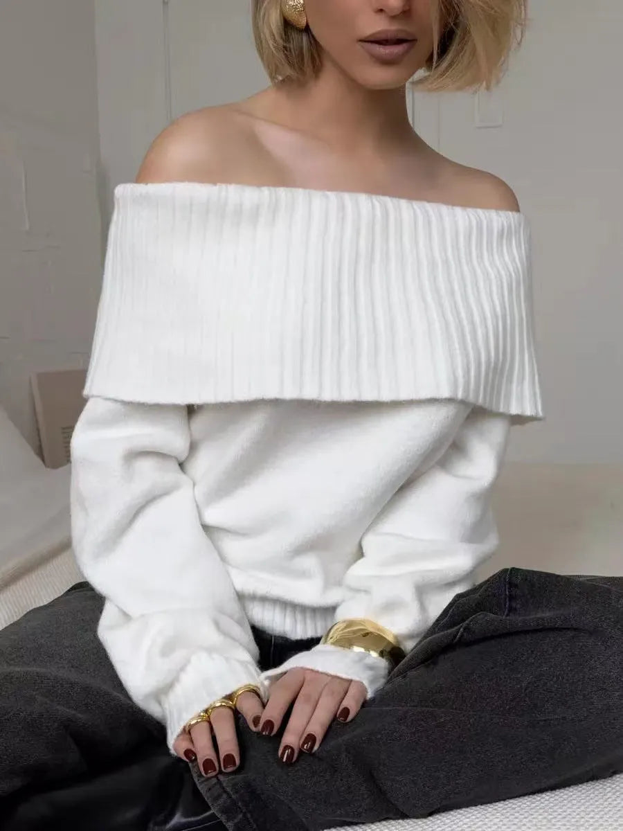 Grey off-the-shoulder sweater with a 3D pattern, shown on a model.