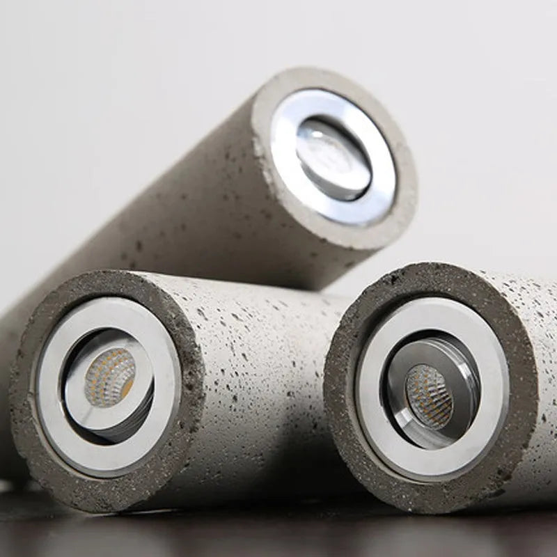 Cement industrial bedside droplight with water pipe design, glossy finish, on a wooden table