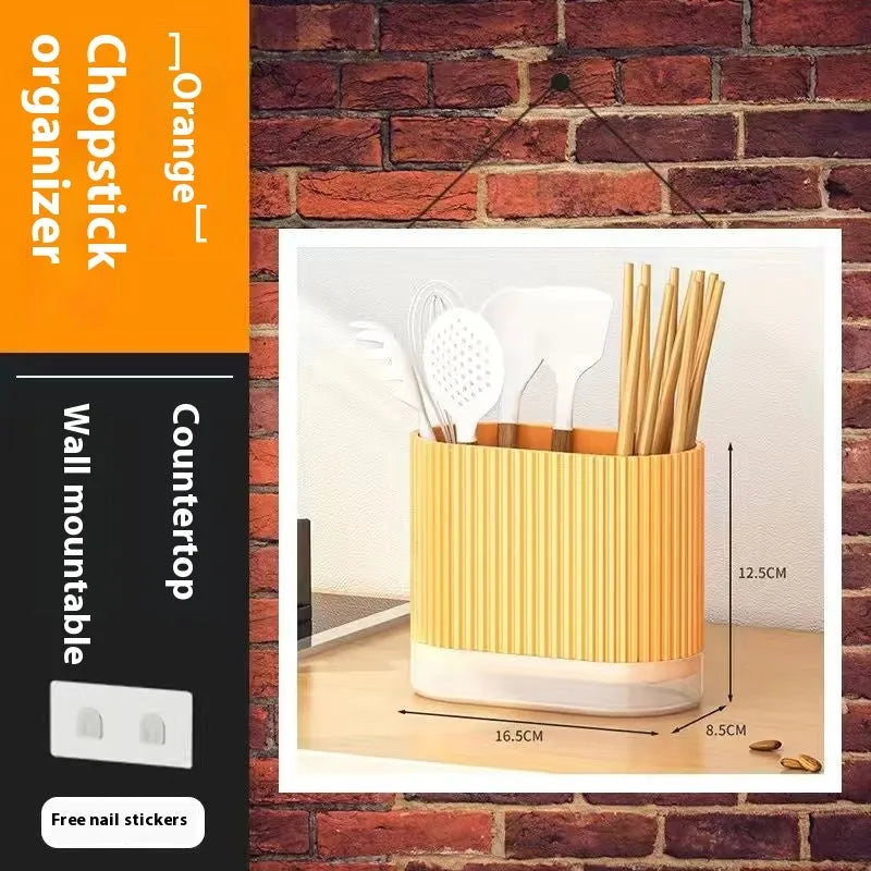 Modern plastic chopsticks tube holder mounted on kitchen wall holding utensils