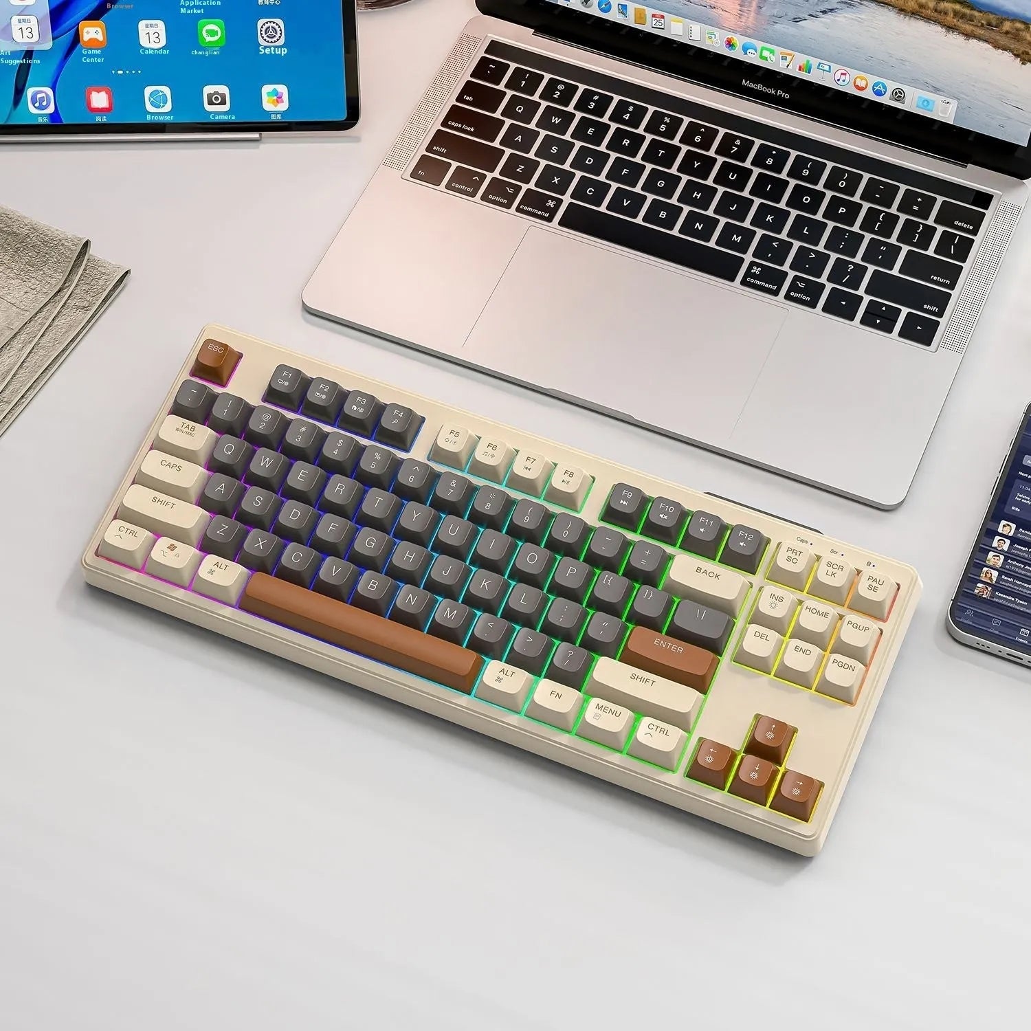Compact wireless Bluetooth keyboard in blueberry colour with USB receiver and cable on a desk.