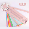 Pink and black 12-in-1 dotted line plastic rotary paper cutting machine on a craft table.