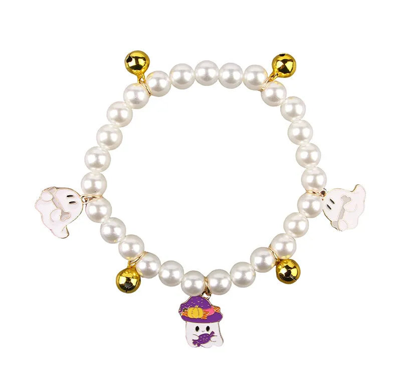 Halloween pet collar with simulated pearls and a purple ghost pumpkin charm around a cat's neck.