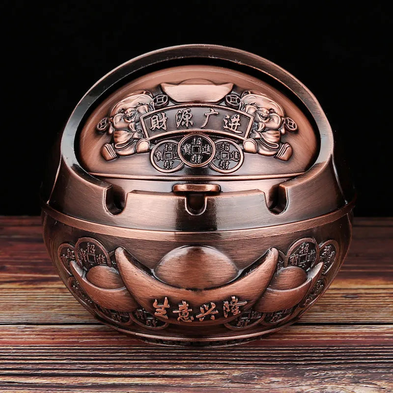 Bronze alloy ashtray with decorative fortune tree design and smoke extinguishing slot.