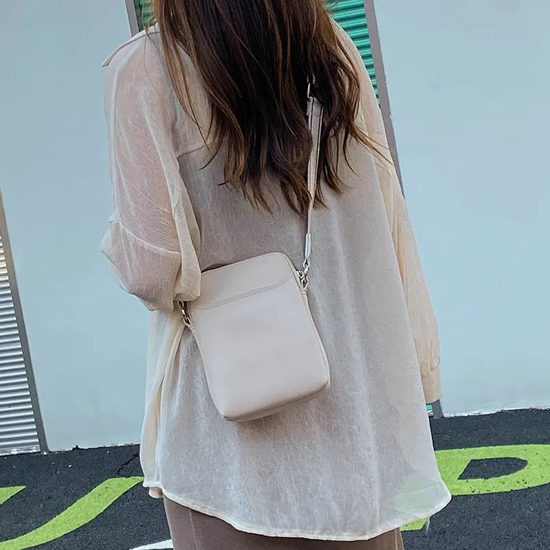 Solid colour PU leather crossbody phone bag in beige, shown with adjustable strap.