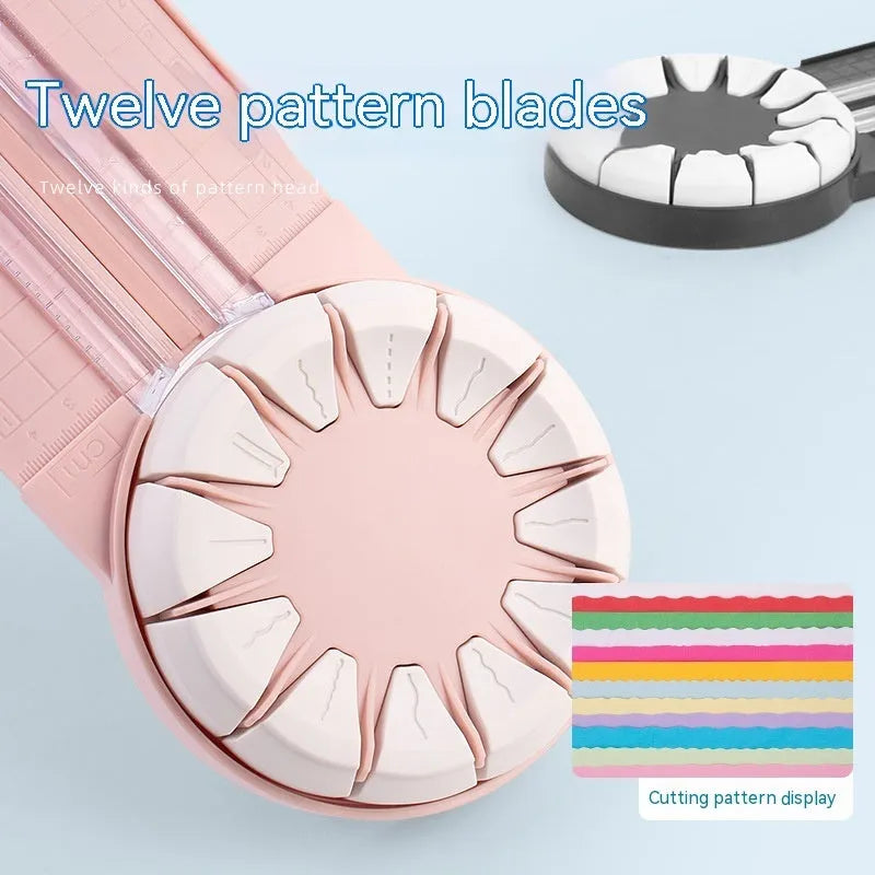 Pink and black 12-in-1 dotted line plastic rotary paper cutting machine on a craft table.