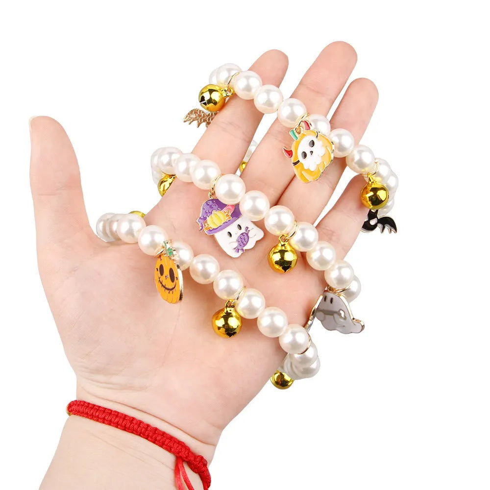 Halloween pet collar with simulated pearls and a purple ghost pumpkin charm around a cat's neck.