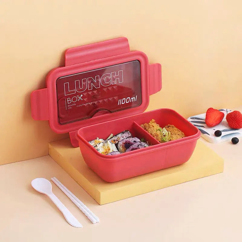 Green four-layer partitioned plastic bento lunch box with lid open.