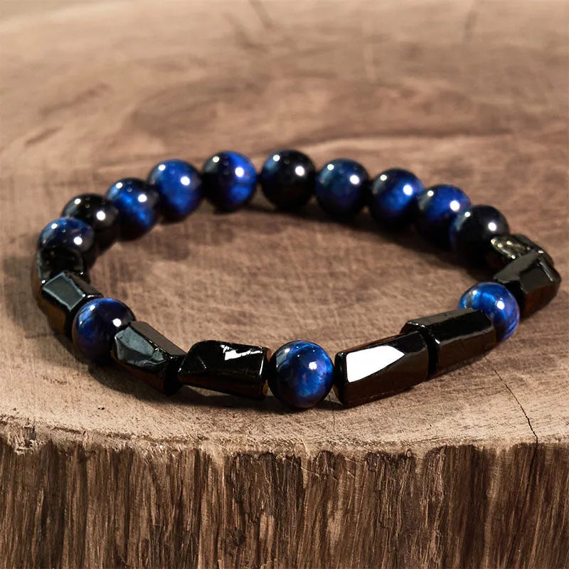 Natural obsidian single ring bracelet with constellation modelling on a wrist.