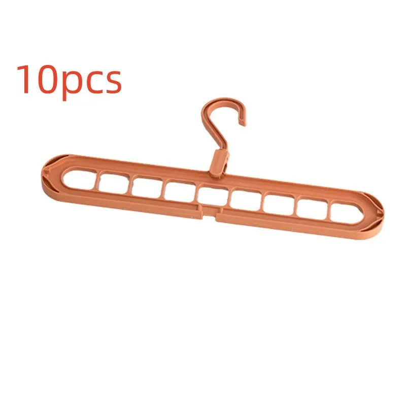 Green nine-hole plastic folding hanger for trousers and skirts showing multiple garment hanging points