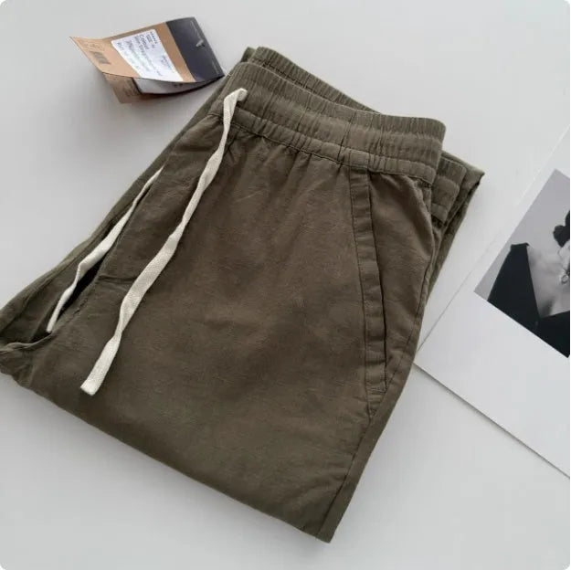 Men's loose fit straight leg casual trousers in beige with a drawstring waistband.