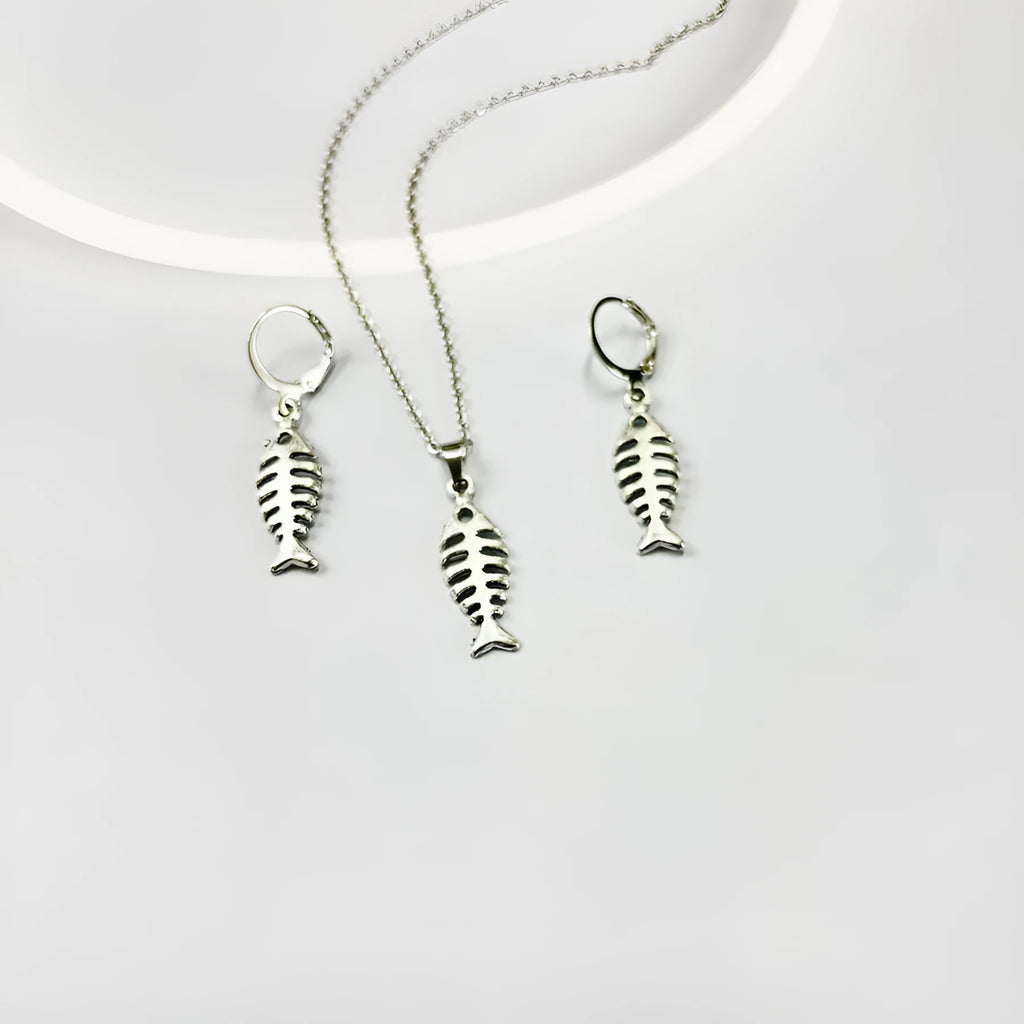 Fishbone pendant necklace and matching earrings set with adjustable chain on grey background