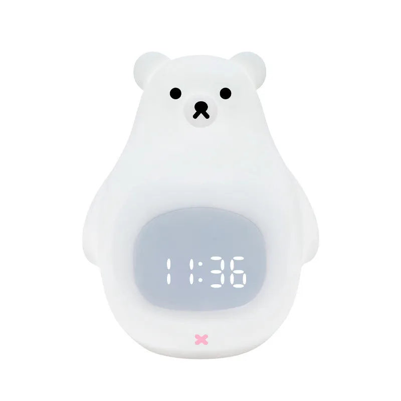 White silicone bear-shaped night light with remote control on a bedside table.