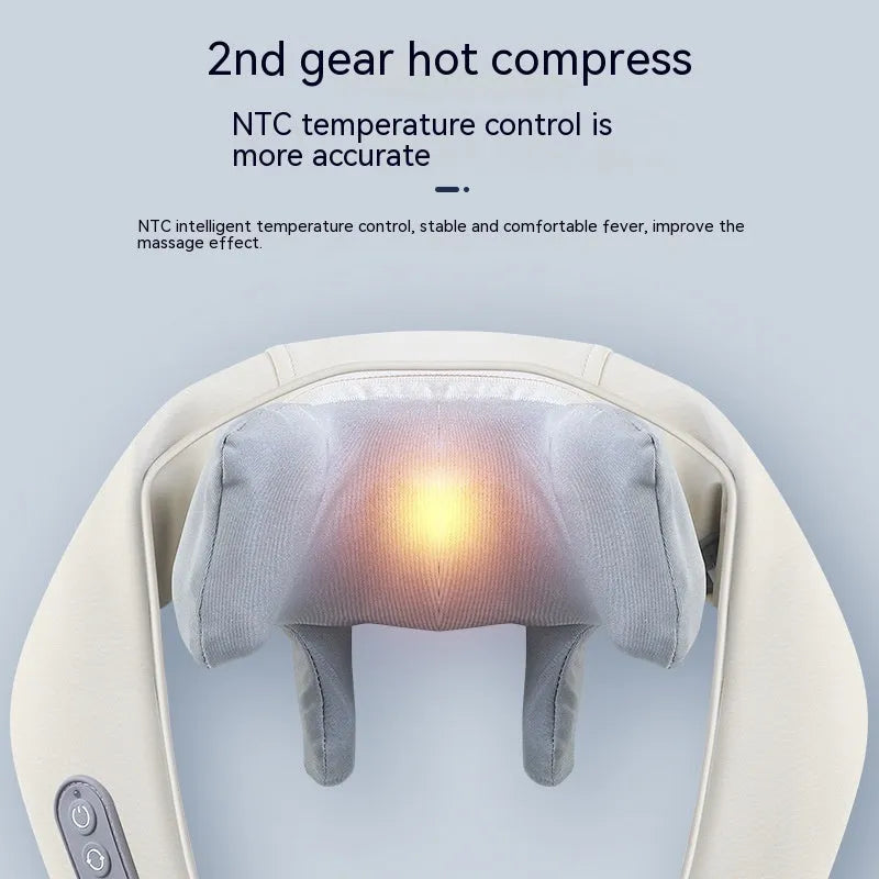 Beige neck massage pillow with six massage heads and wireless remote control on a table