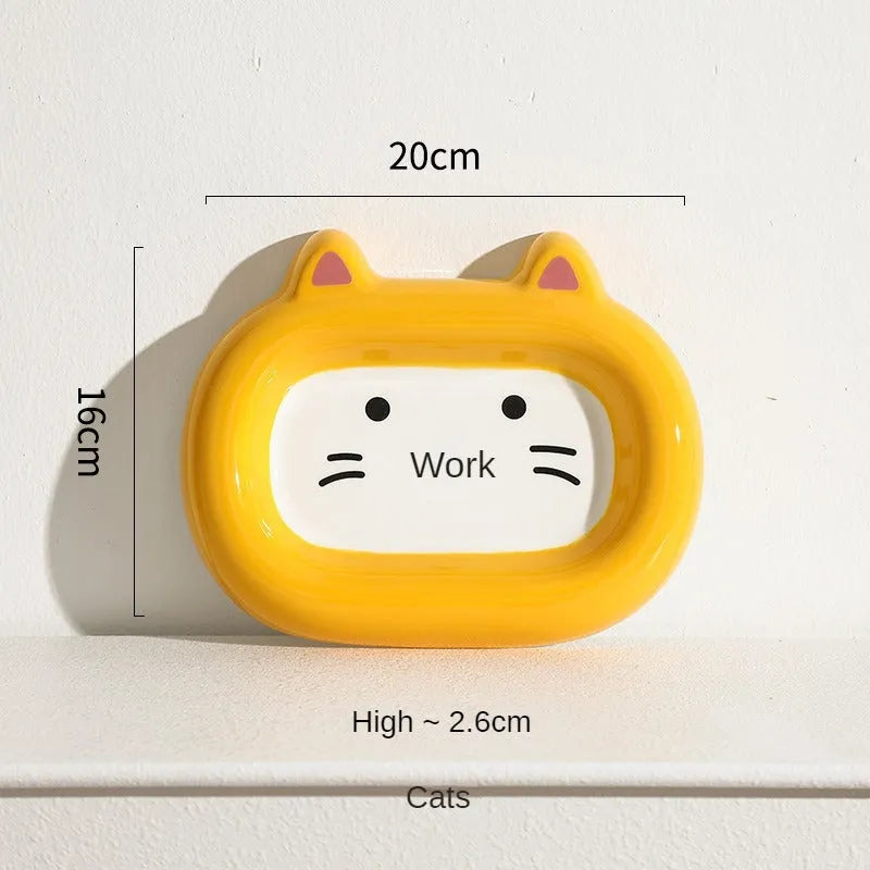 Glazed ceramic pet food bowl with animal design and non-slip rubber base ring.