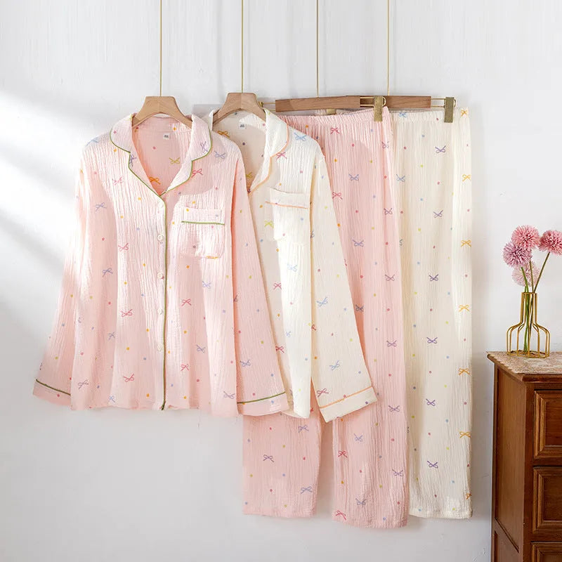 Women's beige cotton crepe pajama set with long sleeves and trousers on a hanger