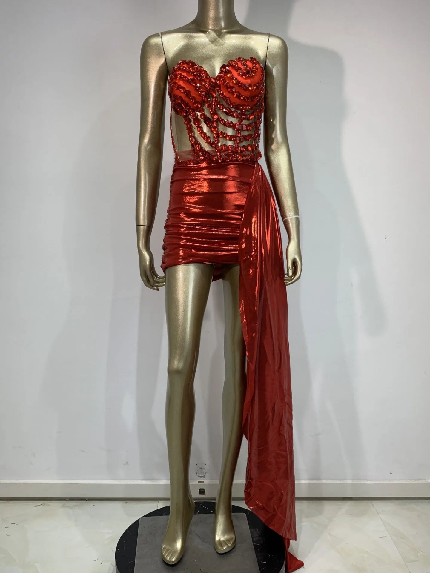 Red women's spandex skirt suit with see-through hollow mesh panels for stage performance.