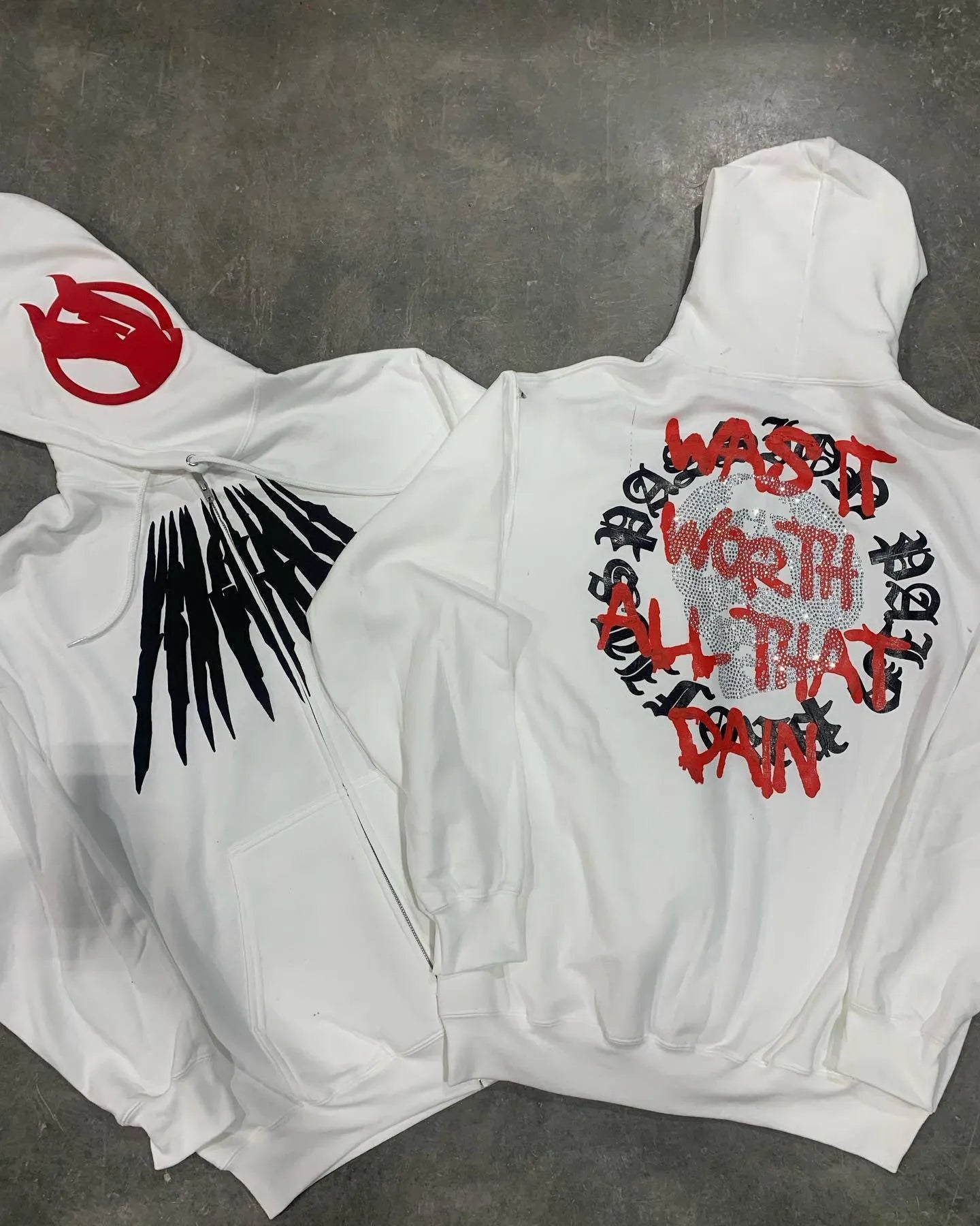 Black loose hooded sweatshirt with white skull and letter print, detailed with hot rhinestones.