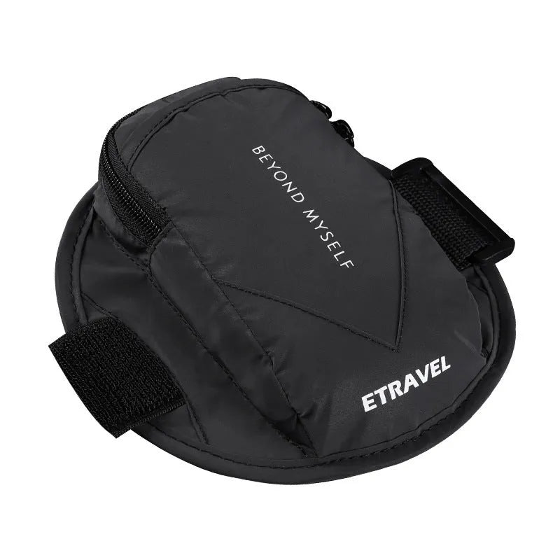 Black reflective running arm bag with adjustable strap, shown on a runner's arm at dusk.