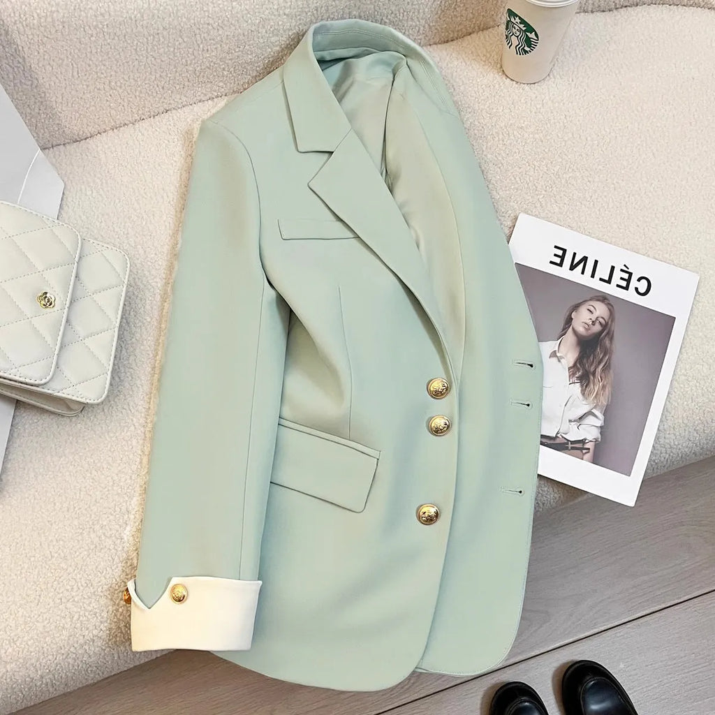 Women's loose fit Korean style coat in milky white, showing long sleeves and pockets.