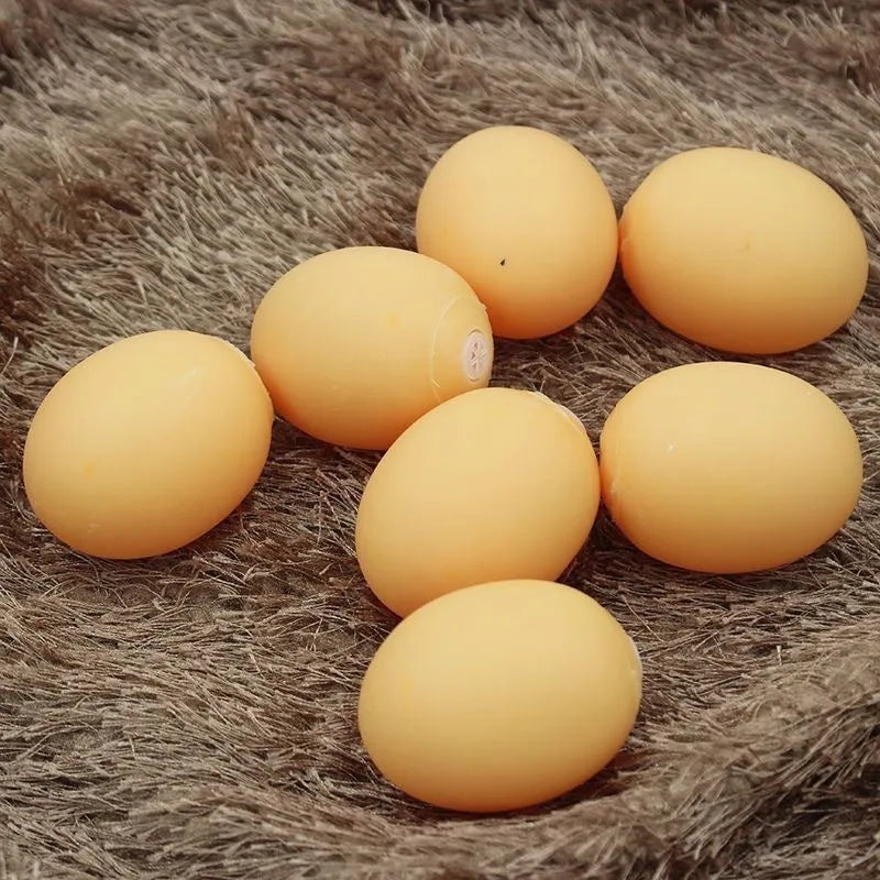 Red rubber egg-shaped dog chew toy with squeaker sound mechanism for dental care and interactive play.