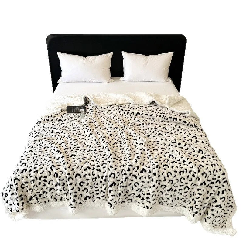 Double-layer cationic leopard jacquard taffeta blanket showing reversible design with zebra pattern