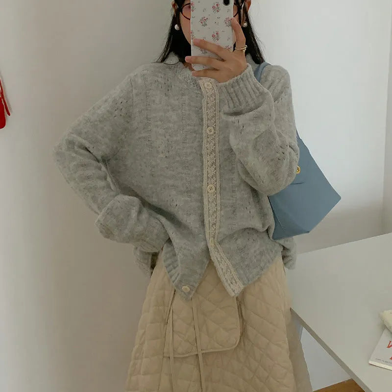 Retro style loose-fit viscose fibre cardigan in apricot colour, shown on a hanger.