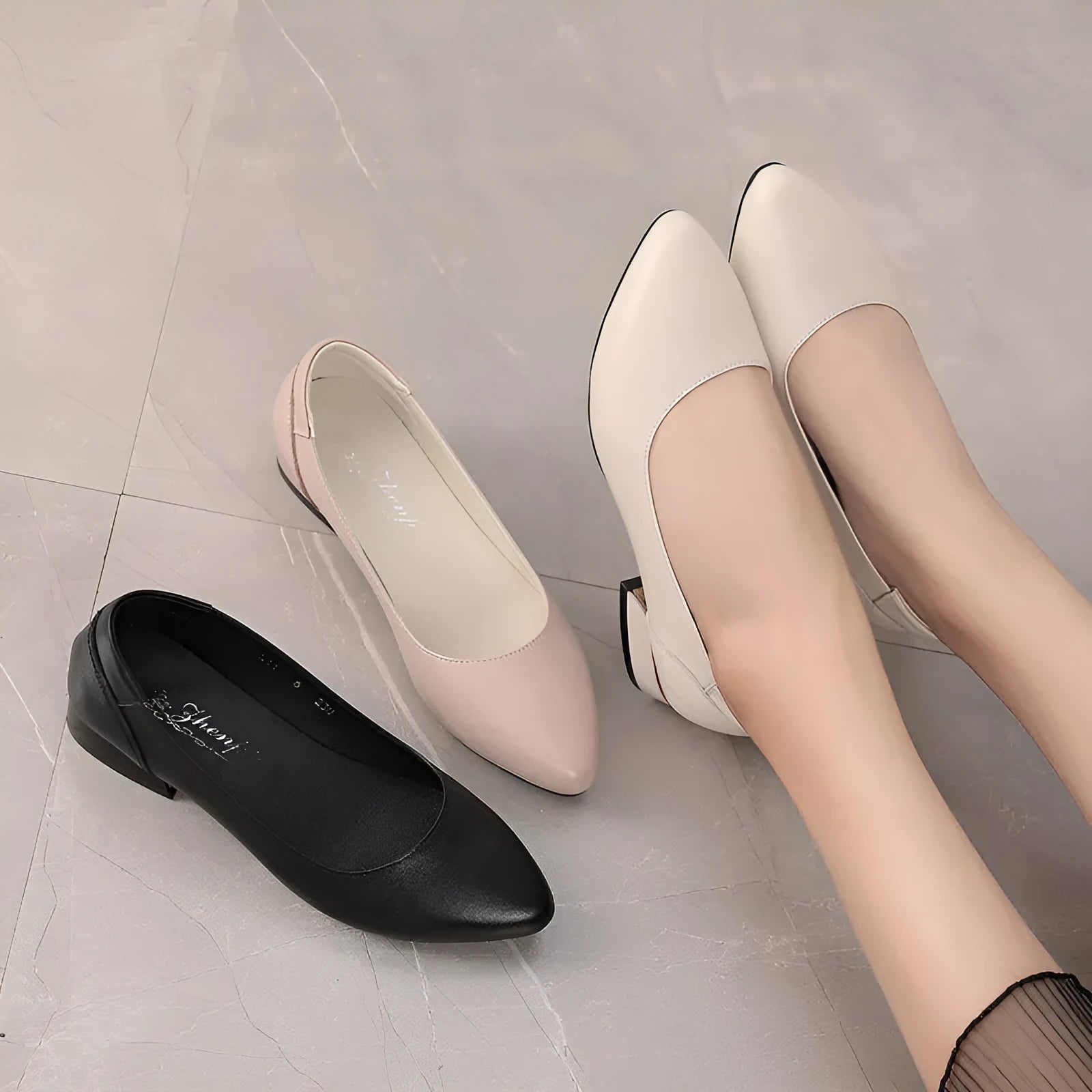 Beige low top casual shoes with pointed toe, buckle fastening, and a thick flat heel.
