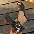 Women's black retro chunky heel slippers with a metal buckle and rubber sole.