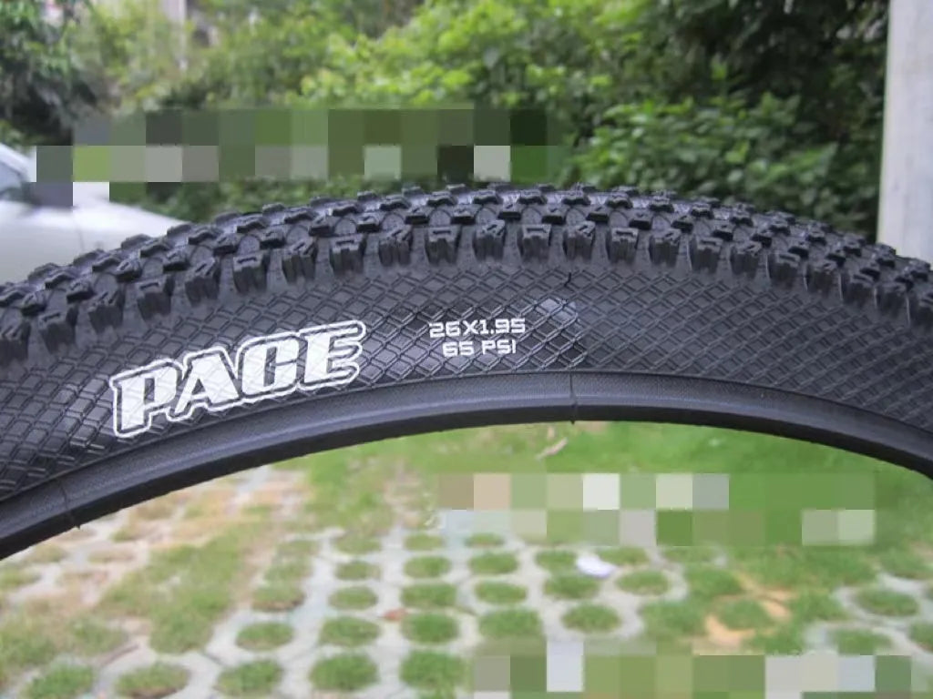 Ultralight mountain bike tyre with puncture-resistant tread, shown in a black and white sidewall style.