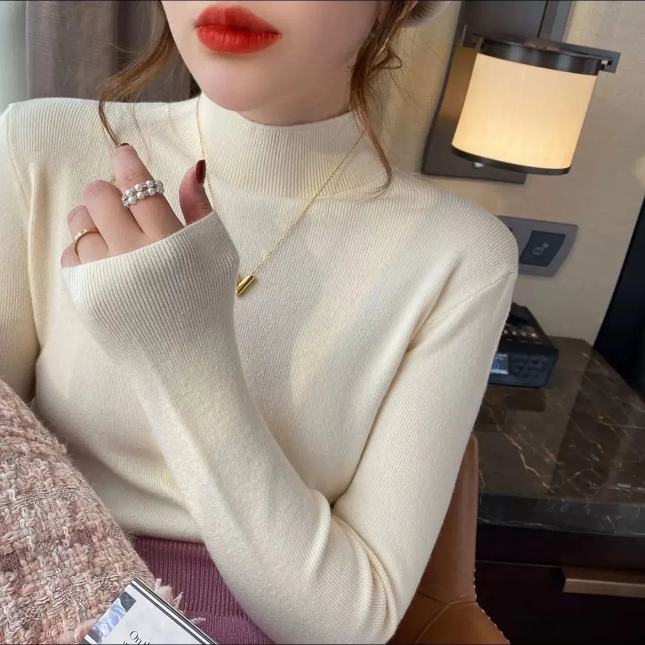 Slim fit apricot coloured viscose fibre knitted inner shirt with long sleeves laid flat.
